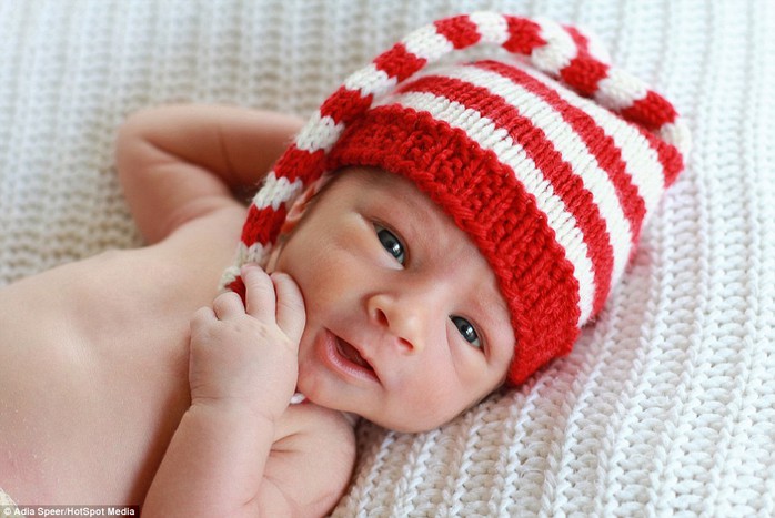 Adia says: Not all newborns like to be swaddled or tolerate being put into a basket. In this picture Brayden, under two weeks old, opens his eyes as he shows off his Christmas hat