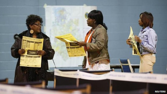 Voters assess the options as they queue in Charlotte, North Carolina, 4 Nov