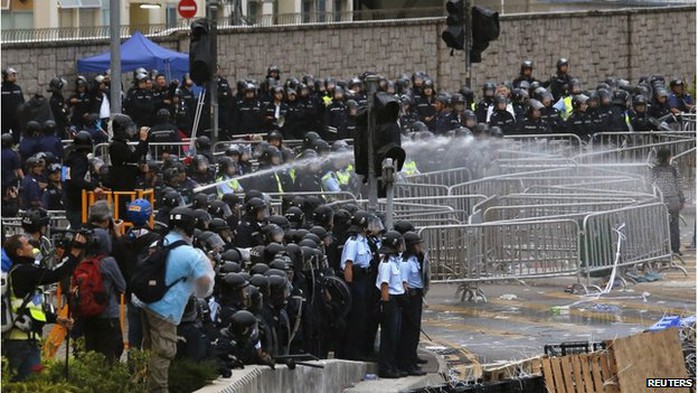 Riot police use a water cannon to disperse protesters during clashes outside the government headquarters in Hong Kong 1 December 2014