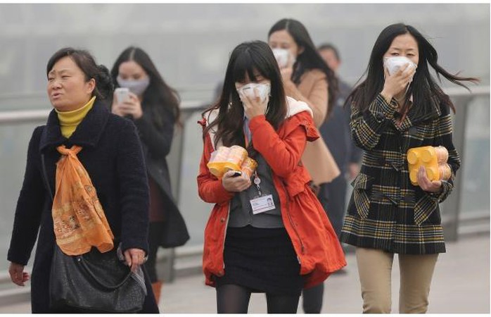 Workers wear the masks to protect them from air pollution in Shanghai, China, Friday, Dec. 6, 2013. Shanghai authorities ordered schoolchildren indoors and halted all construction Friday as China’s financial hub suffered one its worst bouts of air pollution, bringing visibility down to a few dozen meters and obscuring the city’s spectacular skyline.