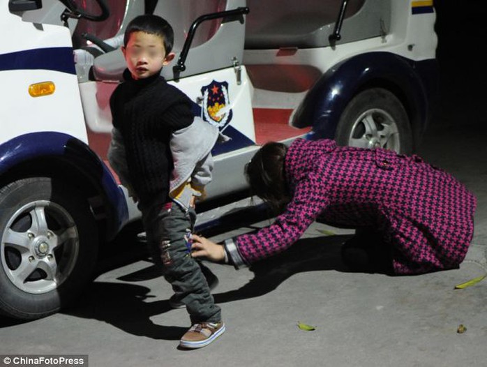 A mother cries as she intends to give up her child. Abandoning children is illegal in China, but the hatches were introduced so parents could abandon infants safely rather than leaving them in the streets