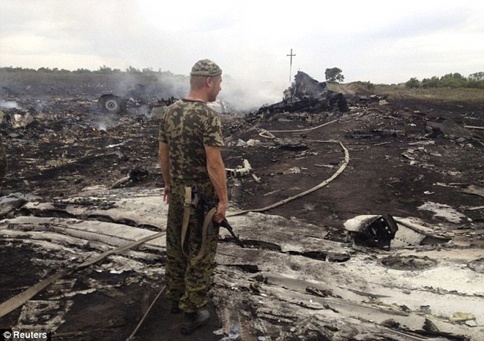 Destroyed: An armed pro-Russian separatist stands at a site of a Malaysia Airlines Boeing 777 plane crash in the settlement of Grabovo in the Donetsk region of Ukraine. It is claimed the flights black box has been recovered and will be sent to Moscow