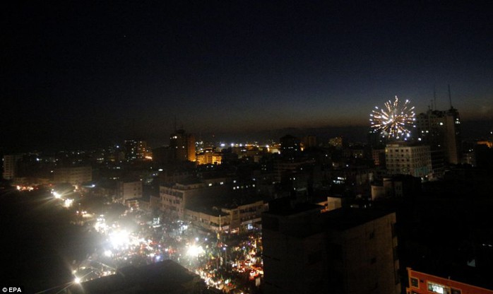 Fireworks: Palestinians set off fireworks as the gather in the streets after Israel and Hamas agreed what it was hoped would be a long-term truce