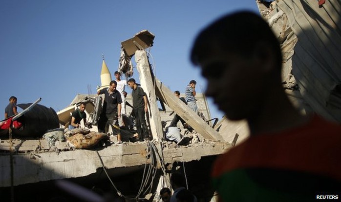 Người dân Palestine hứng chịu cuộc không kích của quân đội Israel đêm 20-8. Ảnh: Reuters
