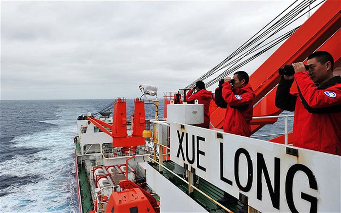 Crew members of Chinese icebreaker Xuelong search for the missing Malaysia Airlines Flight MH370 