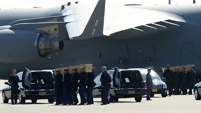 Coffins of the victims of Malaysia Airlines MH17 downed over rebel-held territory in eastern Ukraine, are carried from an aircraft during a national reception ceremony at Eindhoven airport July 23, 2014. (Reuters/Toussaint Kluiter)