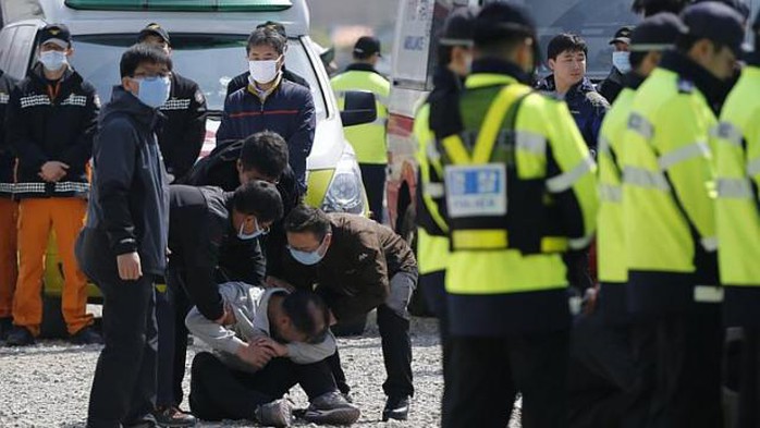 Một người đàn ông gục khóc đau đớn khi chờ tin người thân trên tàu Sewol. Ảnh: Reuters