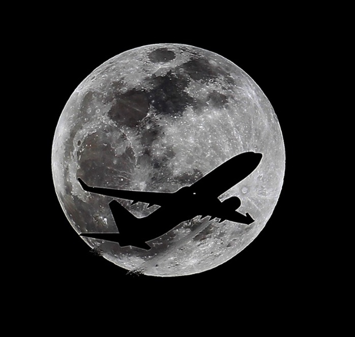 A plane crosses the moons path over Whittier, California, approximately one hour before the total lunar eclipse. Photograph: Nick Ut/AP