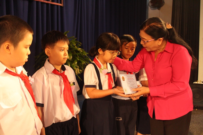 Bà Nguyễn Thị Bích Thủy, Phó Chủ tịch LĐLĐ TP HCM, tặng học bổng cho các em