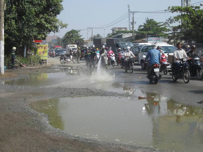 Lực lượng chức năng phải xịt nước để rửa sạch hóa chất trên đường