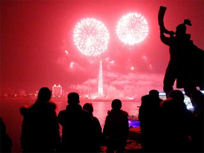 Fireworks explode over Juche Tower and the Taedong River in Pyongyang, North Korea to celebrate the New Year on Wednesday, Jan 1, 2014. (AP Photo/Kim Kwang Hyon)