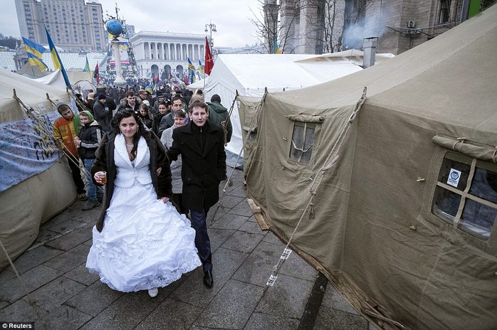 A couple of newlyweds visit a scene where pro-European integrations supporters hold a rally in Kiev, Ukraine on December 21