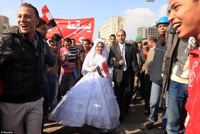 A bride and groom celebrate their wedding in Cairo's Tahrir Square, to show their support for protesters