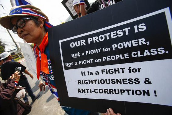 An anti-government protester holds a placard during a rally in Bangkok January 27, 2014. REUTERS-Athit Perawongmetha