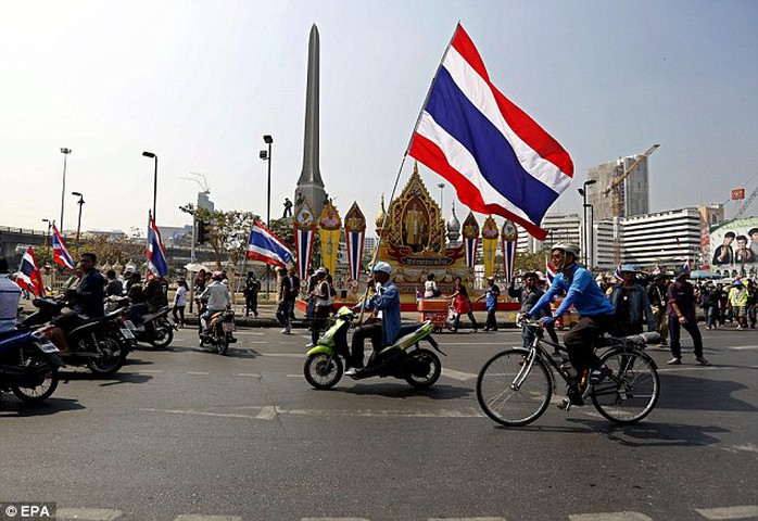 Defiant: Supporters of anti-government protest leader Suthep Thaugsuban demonstrate on a main road next to Victory Monument in central Bangkok today