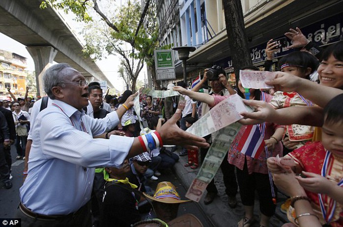 Support: Protest leader Suthep Thaugsuban collects donations during a march through Bangkok today