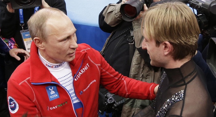 Russian President Vladimir Putin (left) shakes hands with Evgeni Plushenko of Russia during the 2014 Winter Olympics, Feb. 9, in Sochi, Russia. | AP Photo