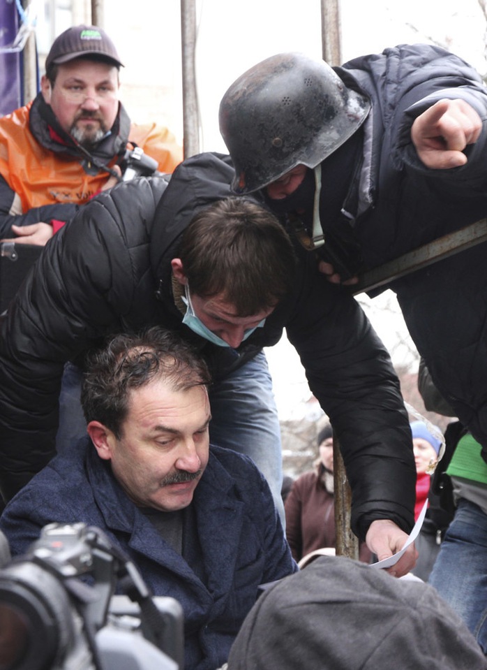 Anti-government protesters capture Volyn Region Governor Alexander Bashkalenko (L, bottom) during a rally in the town of Lutsk in northwestern Ukraine, February 19, 2014. (Reuters/Cathal McNaughton)