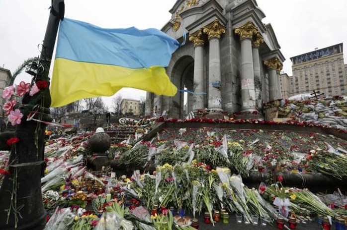 Ukraines national flag flies at a make-shift memorial for those killed in recent violence in Kiev February 25, 2014. REUTERS-Konstantin Chernichkin