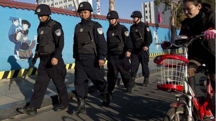 Armed policemen patrol on a street near the Kunming Railway Station in western Chinas Yunnan province, 3 March 2014