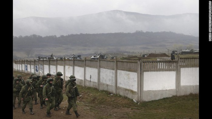 Armed men believed to be Russian military march in the village outside Simferopol, Ukraine, on Friday, March 7.