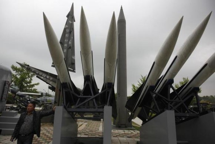 A visitor poses for a photo next to a display of mock South Korean U.S.-made Hawk surface-to-air missiles and a mock North Korean Russian-made Scud-B ballistic missile (C, in gray), at the Korean War Memorial Museum in Seoul May 20, 2013. REUTERS/Kim Hong-Ji