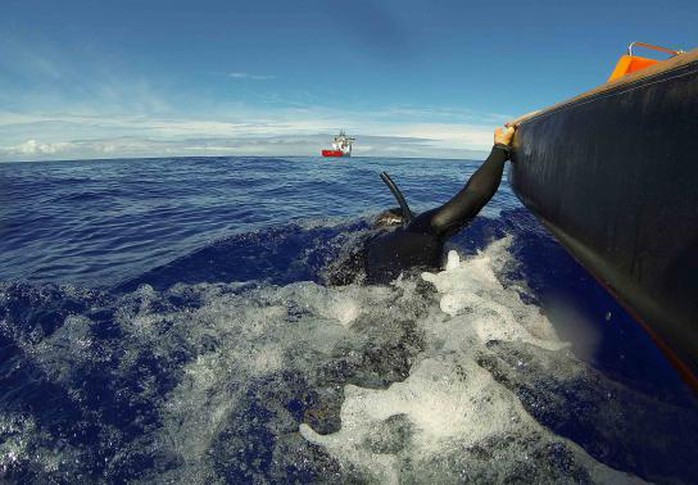 A fast response craft from Australian Defence Vessel Ocean Shield tows Able Seaman Clearance Diver Michael Arnold as he searches the ocean for debris in the search zone in the southern Indian Ocean for the missing Malaysian Airlines flight MH370 in this picture released by the Australian Defence Force April 8, 2014. REUTERS-Australian Defence Force-Handout