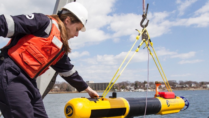 A submarine built by Bluefin Robotics is lowered into the water on Wednesday. Bluefin Robotics shipped a version of their submarine to help locate the missing Malaysian Airlines Flight 370, by using its side-scan sonar.