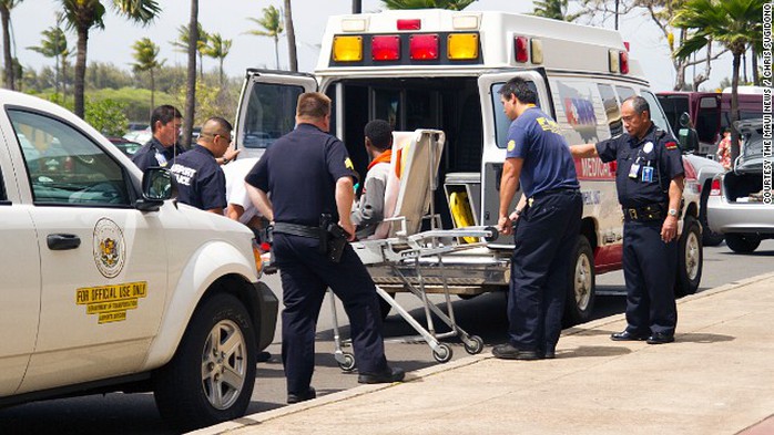 The boy who says he stowed away in the wheel well of a flight from California to Hawaii is loaded into an ambulance.