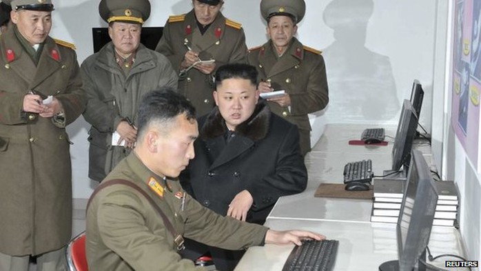 This undated picture released by North Koreas official Korean Central News Agency (KCNA) on 14 December 2013 shows North Korean leader Kim Jong-Un (C) inspecting a military design institute at an undisclosed location in North Korea