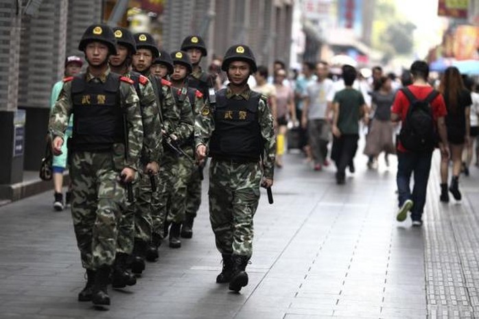 Paramilitary policemen patrol along a street in Shenzhen, Guangdong province, May 27, 2014.     REUTERS-Stringer