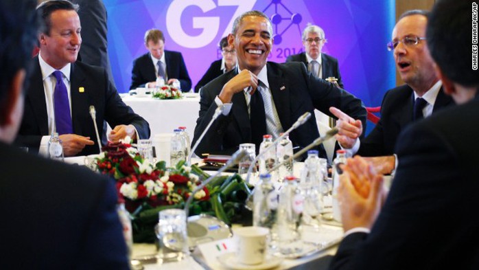 President Barack Obama laughs with British Prime Minister David Cameron, left, and French President Francois Hollande during a G7 session in Brussels, Belgium, on Thursday, June 5. Obamas travel agenda includes Poland, Belgium and France.