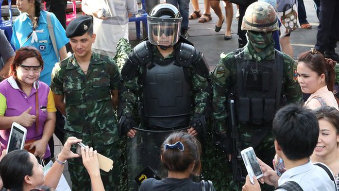 People take photos of Thai special forces officers during an event called 