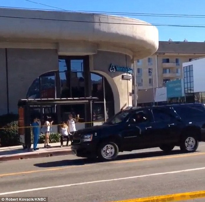 The woman had to sit on a bench at a bus stop across the street fro the hospital until the presidents motorcade passed