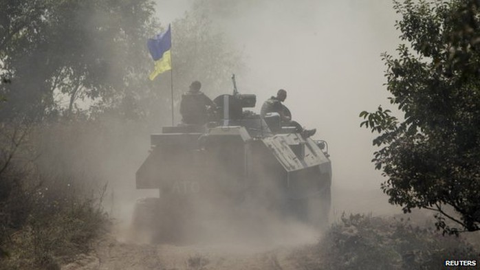 Ukrainian servicemen ride atop an armoured personnel carrier as they patrol an area near Donetsk on 11 August 2014. 