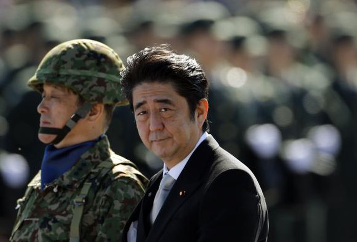 Japanese Prime Minister Shinzo Abe (R) reviews Japanese Self-Defence Forces (SDF) troops during the annual SDF ceremony at Asaka Base in Asaka, near Tokyo, in this October 27, 2013 file photo. REUTERS/Issei Kato/Files