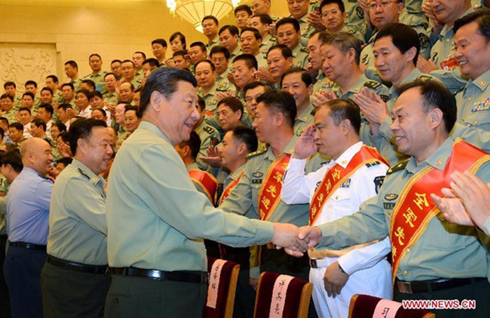 Chinese President Xi Jinping, also general secretary of the Communist Party of China (CPC) Central Committee and chairman of the Central Military Commission, shakes hands with delegates attending a meeting of chiefs of staff of the People