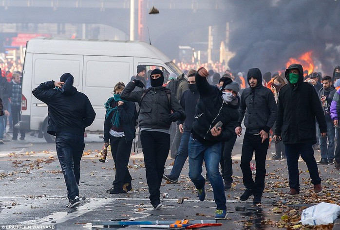 Protesters hurl rocks and bottles: Fighting broke out soon after the end of a largely peaceful march