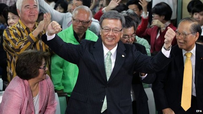 Takeshi Onaga (centre) performs a dance celebrating his victory at the Okinawa gubernatorial election in Naha, southern island of Okinawa, Japan, 16 November 2014