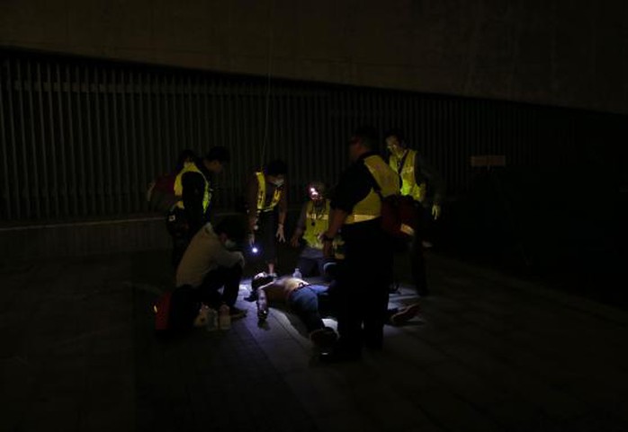 A pro-democracy protester is examined by rescue volunteers after being pepper sprayed by the police as he and others tried to break into the Legislative Council in Hong Kong early November 19, 2014, in response to an earlier clear up by bailiffs on part of the Occupy Central protest site.  REUTERS-Tyrone Siu