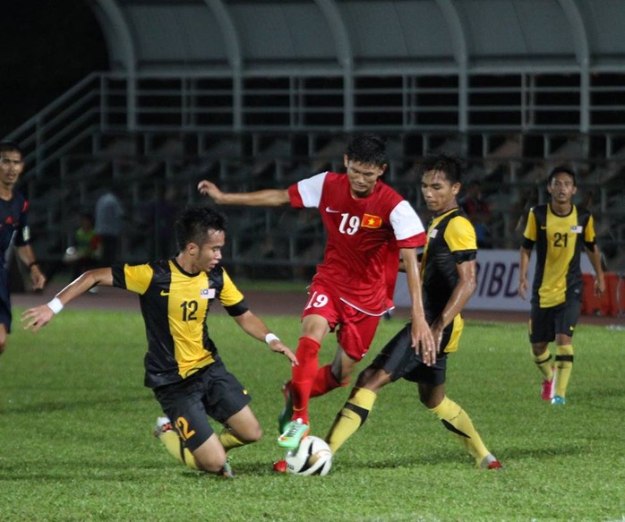 Văn Long đi bóng qua 2 hậu vệ Malaysia