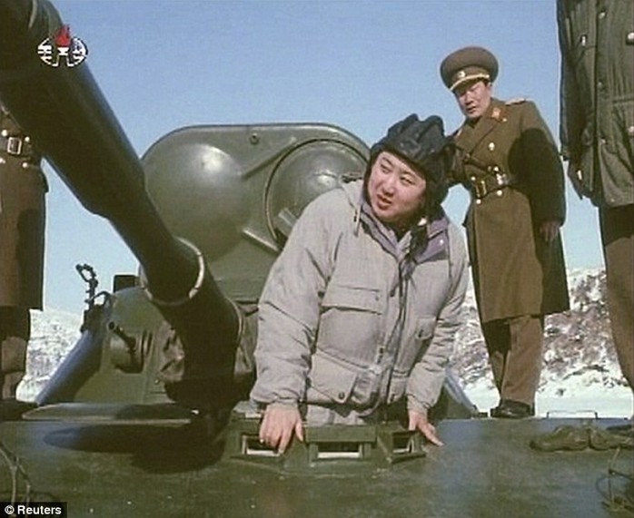 In this image Kim is inspecting a tank during a video documentary at an unknown location in 2012
