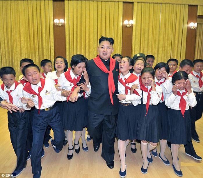 Crying children: Kim walks while flanked by sobbing members of the Korean Childrens Union (KCU) in 2012