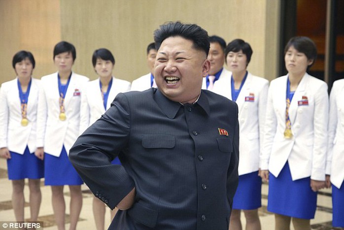 Laughing dictator: North Korean leader Kim Jong Un is all smiles as he meets athletes who won gold medals at the 17th Asian Games