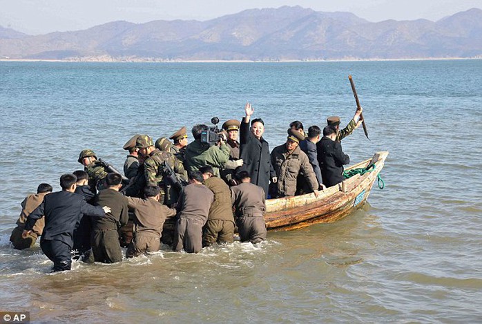 Ahoy! Kim waves at military officers after inspecting the Wolnae Islet Defense Detachment, North Korea, near the western sea border with South Korea in March 2013