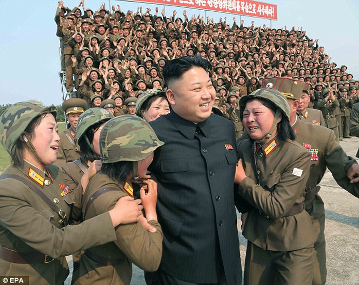 Dear leader: Kim is surrounded by soldiers of a womens artillery unit in North Koreas southeastern province of Kangwon