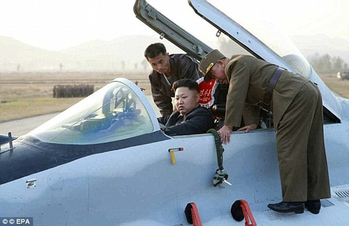 Tight squeeze: Kim is shown the controls of a fighter jet in this propoganda image released late last year