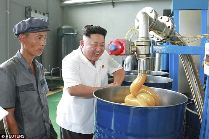 Kim smiles during a visit to the Chonji Lubricant Factory, in this photo taken in Pyongyang in 2014