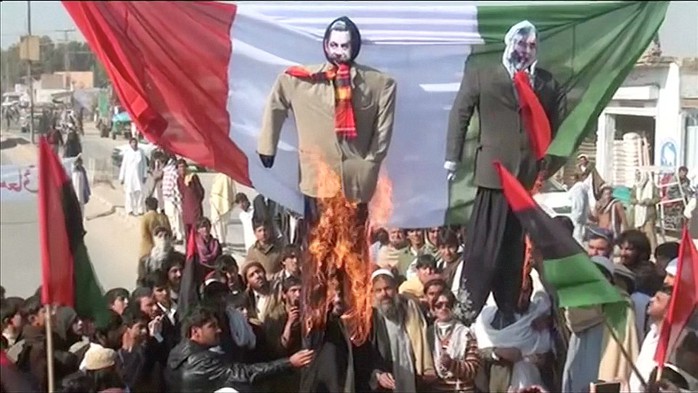 Protesters gathered in the main market square in Bannu, Pakistan, chanting &apos;Death to the government of France&apos;, before setting fire to an effigy of the former French President Nicolas Sarkozy and an effigy of the editor of Charlie Hedbo magazine 