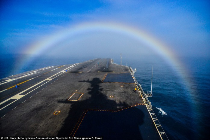 Somewhere under the rainbow: The USS John C. Stennis sails through a rainbow hanging over the Pacific Ocean in this U.S. Navy photo